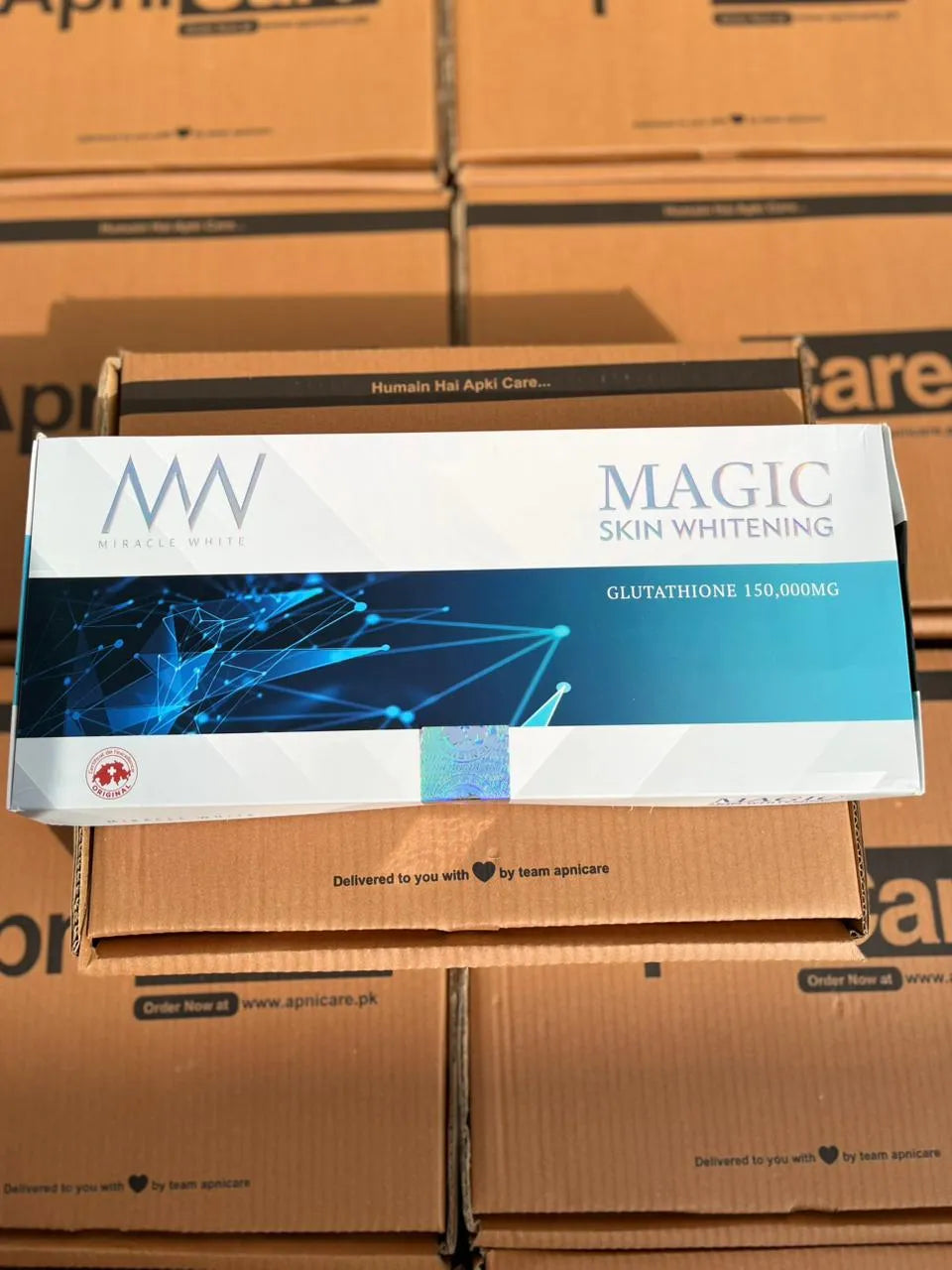 Box of Magic Skin Whitening product on a stack of cardboard boxes